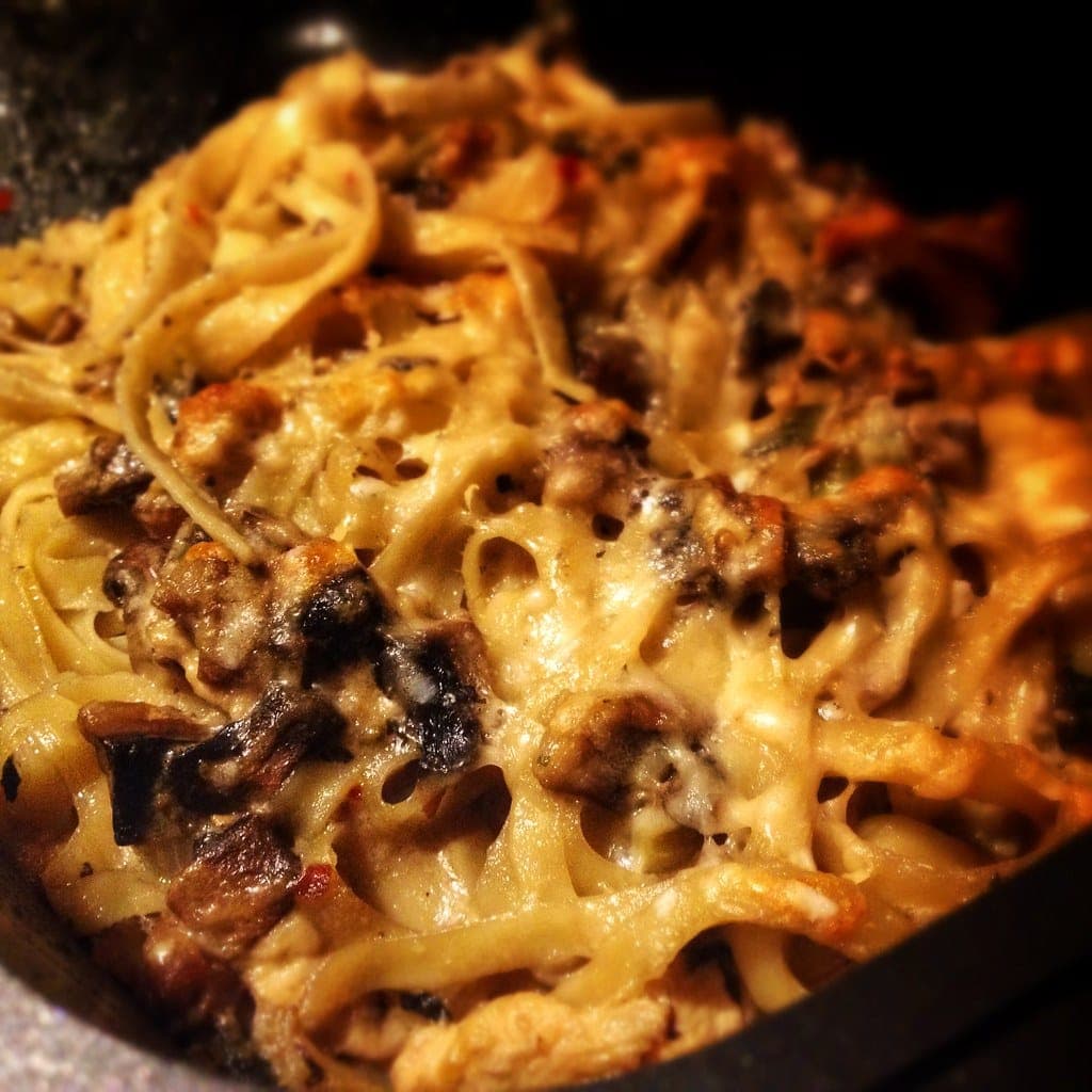 Close-up of baked pasta with mushrooms and melted, browned cheese
