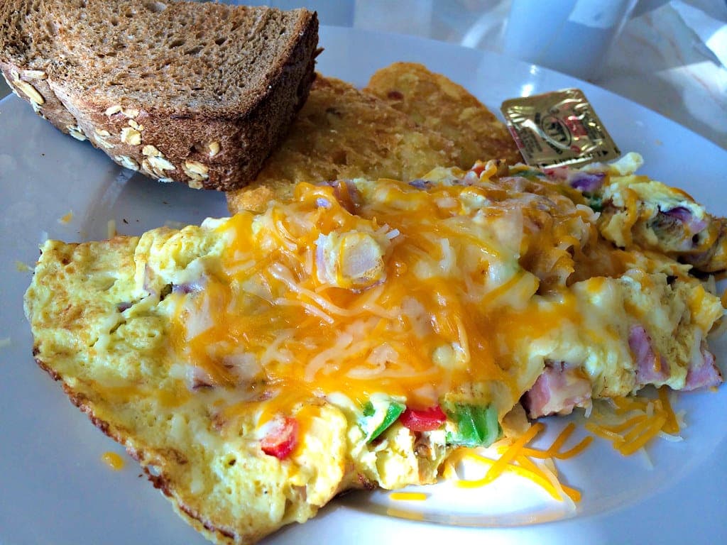 A Denver omelette with peppers, ham and melted cheddar served with toast