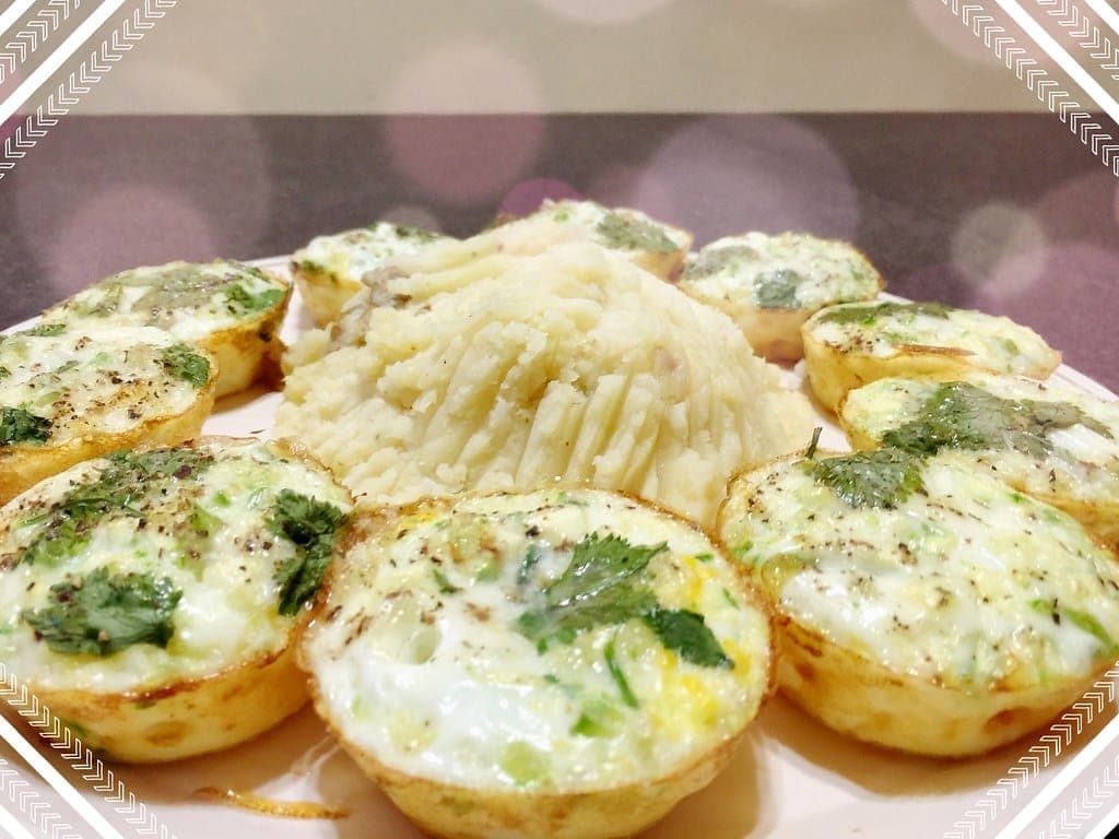 Egg muffin cups flecked with spinach arranged on a platter
