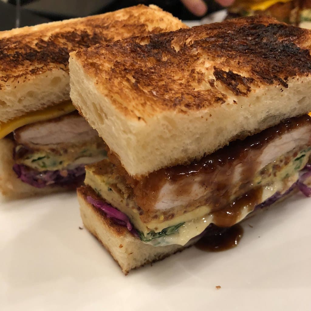 Katsu sando on toasted bread with a breaded pork cutlet, cabbage and dark tonkatsu sauce