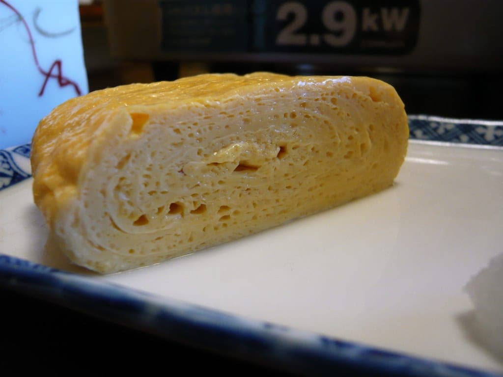 A layered Japanese rolled omelette (tamagoyaki) on a plate