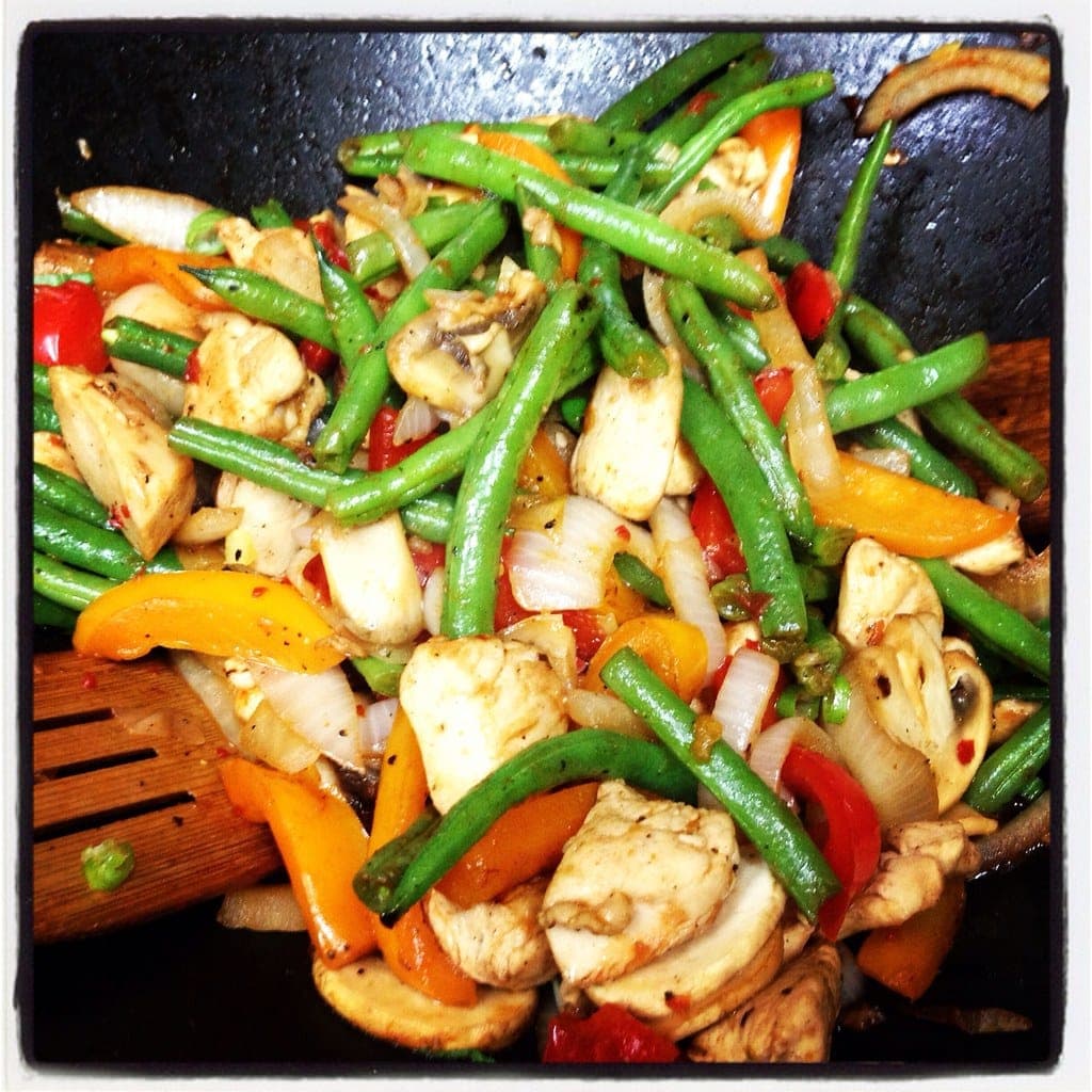 Wok stir-fry of green beans, colourful bell peppers and onion